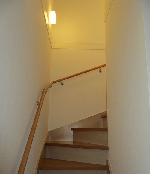 2階へ続く階段。Ｌ字型で省スペースにおさめている。限られた敷地でどこに階段を設置するのがいいのか熟考したと言う。